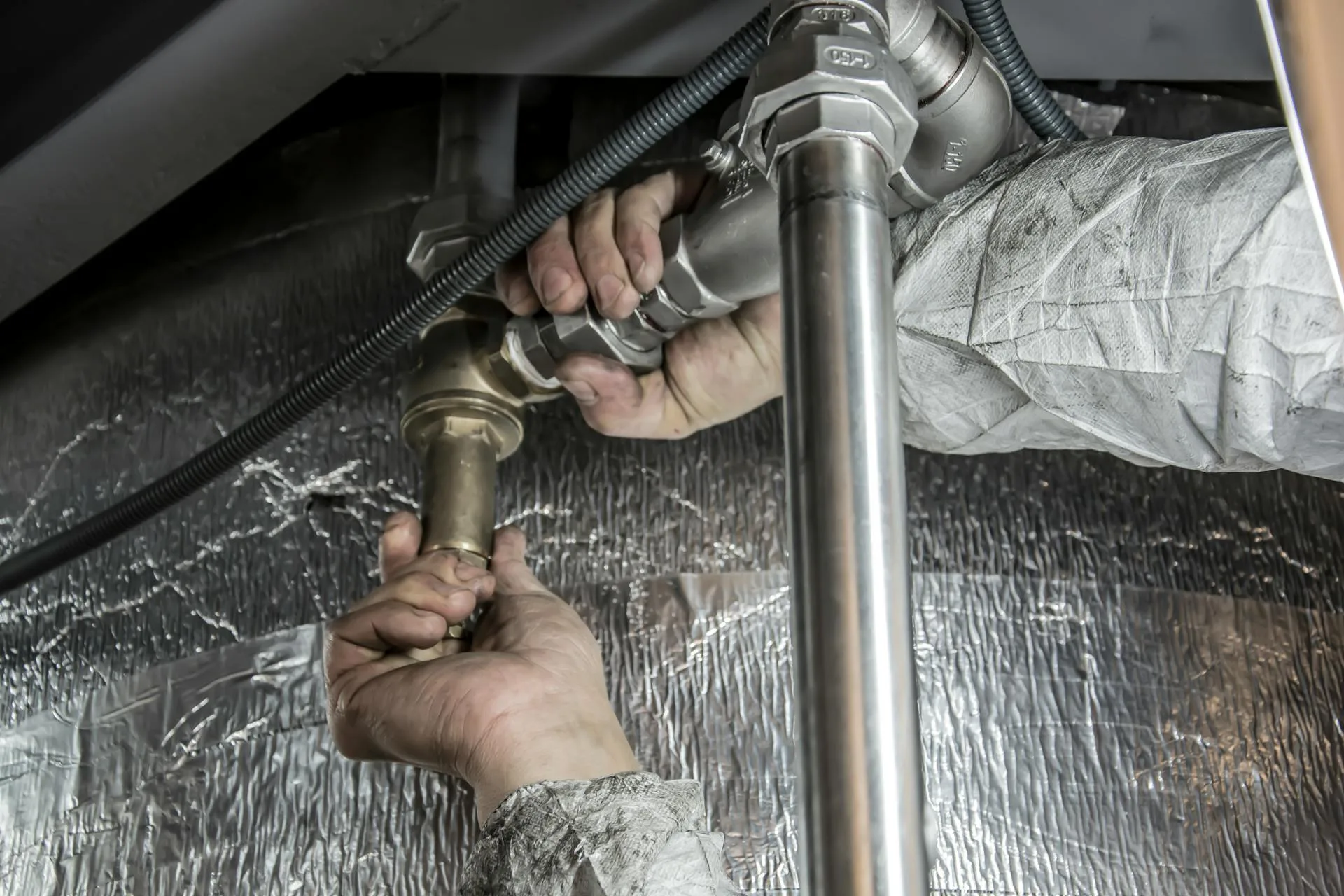 Plumber installing steel pipes - Auckland plumbing services